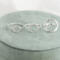 Three open circle sterling silver rings (small, medium, large with hammered finish) on green ring box with flowers.

